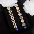 Chanel Script Pendant Earrings - 18K Yellow Gold